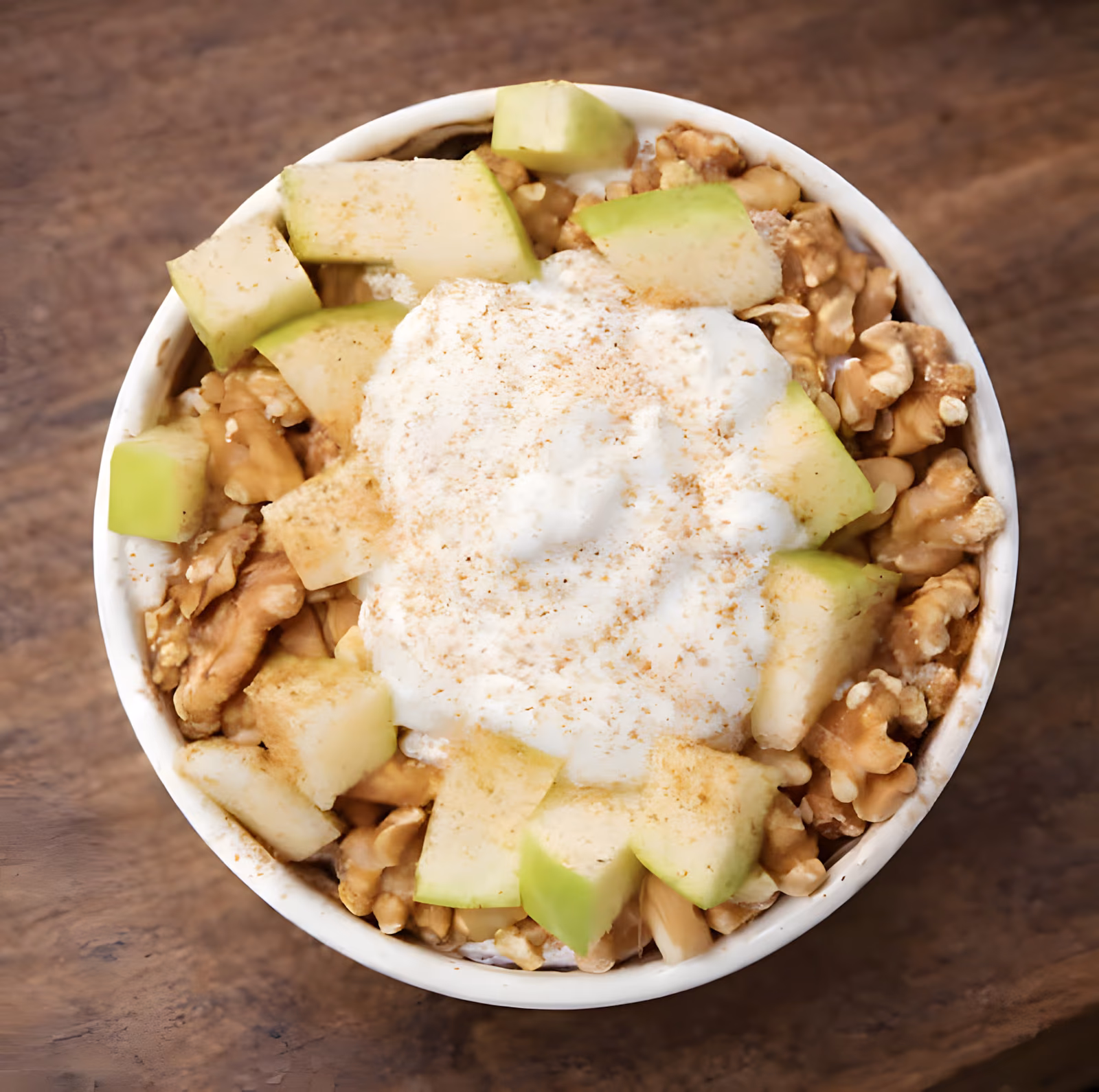 Coconut Apple Warm Bowl topped with coconut yoghurt, fresh apple, walnuts and cinnamon