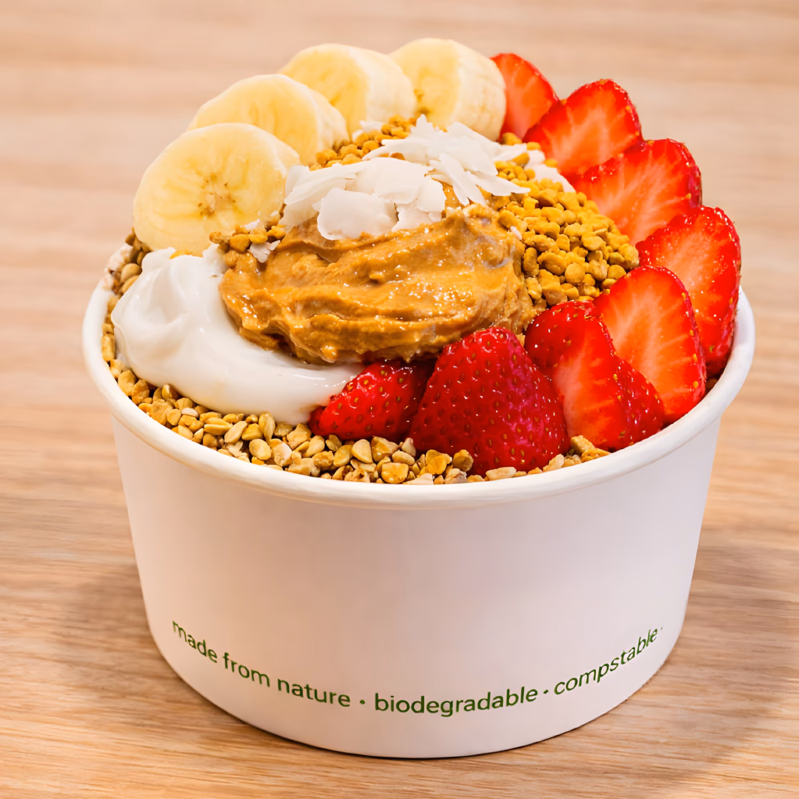 Energizer Acai Bowl topped with peanut butter, banana, strawberries and coconut yoghurt